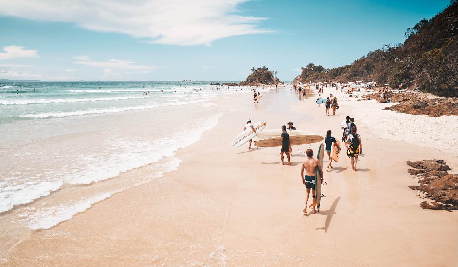 Travellers walking along an Australian beach